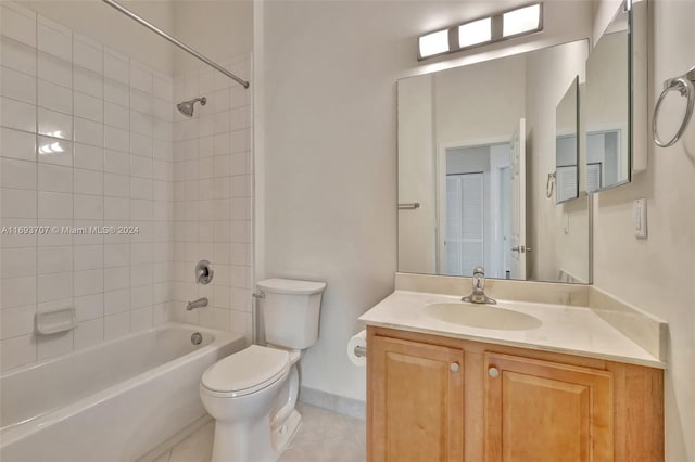 full bathroom featuring tile patterned flooring, vanity, toilet, and tiled shower / bath