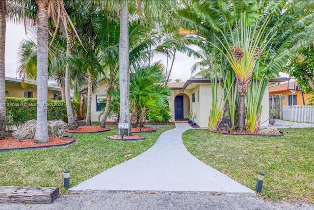 mediterranean / spanish home with a front lawn