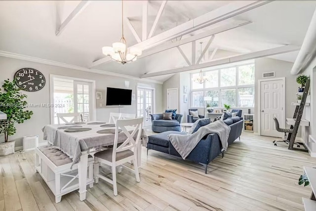 dining space with a wealth of natural light, a chandelier, and light hardwood / wood-style floors