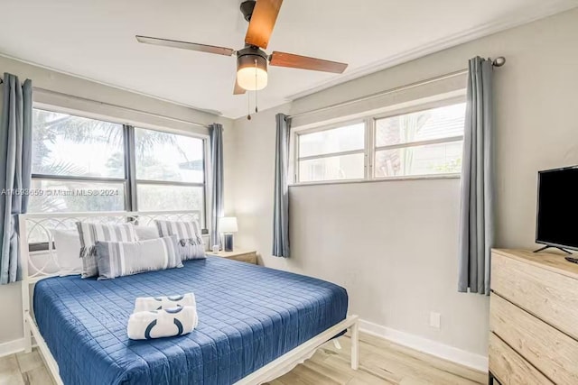 bedroom featuring light hardwood / wood-style flooring and ceiling fan