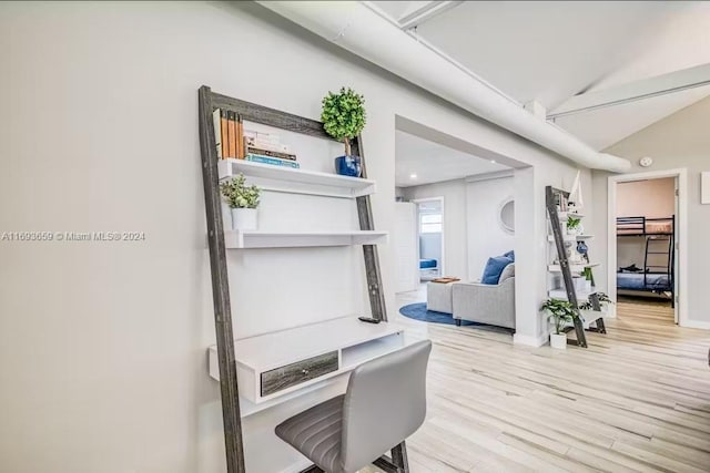 interior space with vaulted ceiling and light hardwood / wood-style flooring