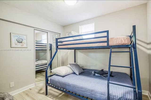 bedroom featuring hardwood / wood-style floors and a closet