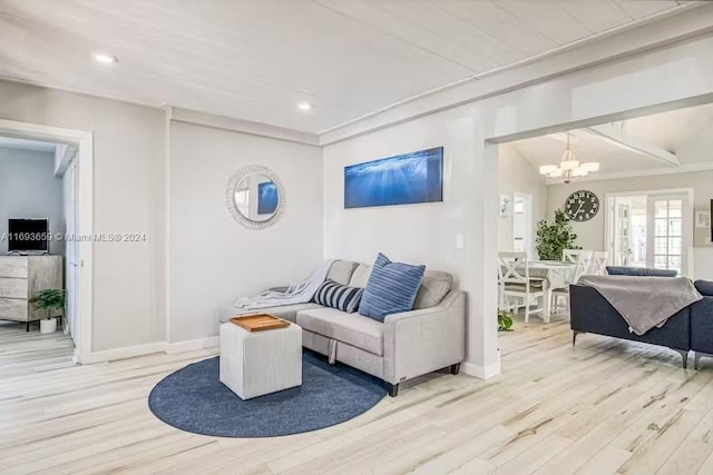 living room featuring light hardwood / wood-style floors and an inviting chandelier