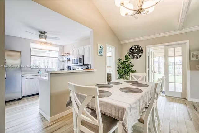 dining space featuring light hardwood / wood-style flooring, a wealth of natural light, and lofted ceiling