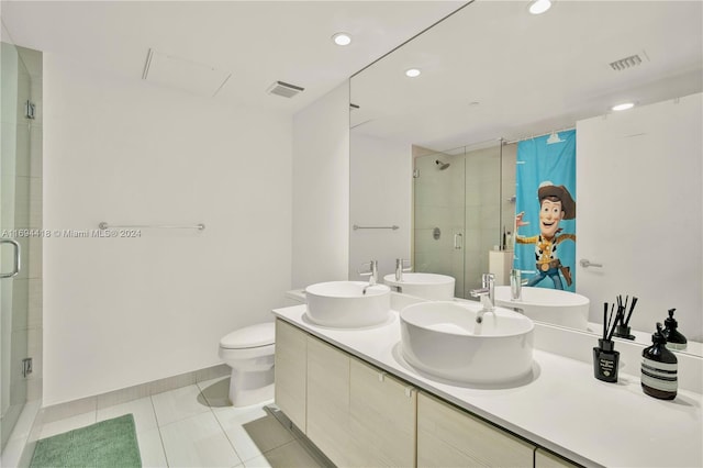 bathroom featuring tile patterned floors, vanity, an enclosed shower, and toilet