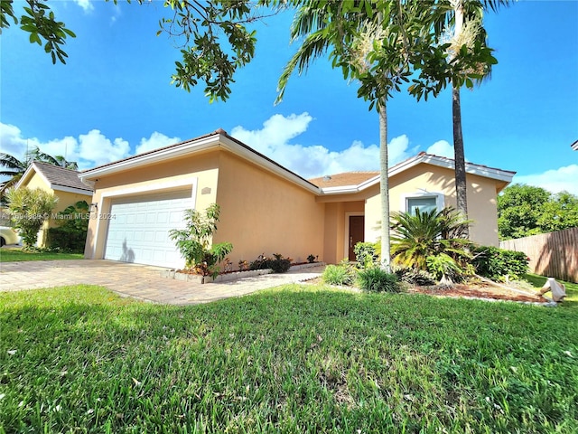 ranch-style home with a front lawn and a garage