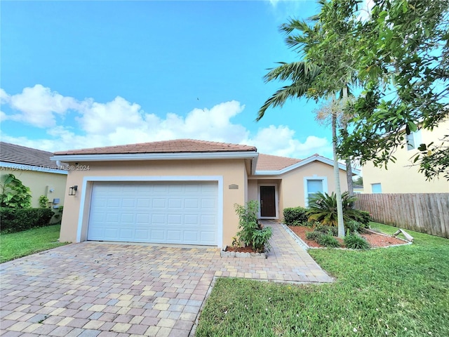 view of front of house with a garage and a front lawn