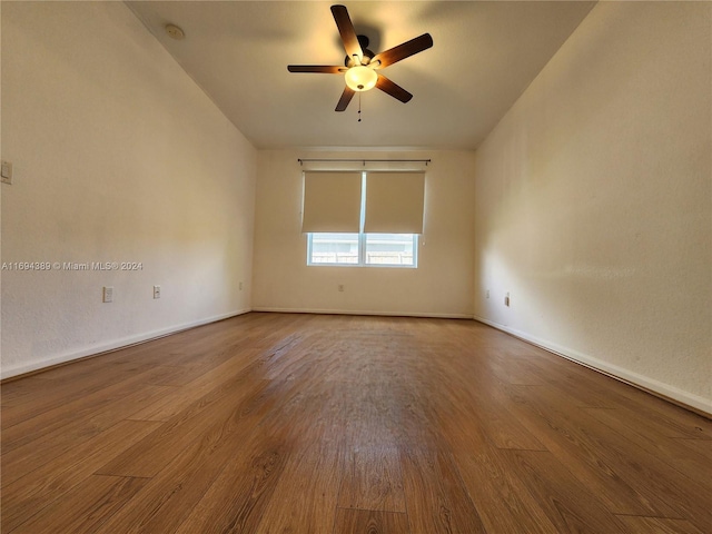 empty room with ceiling fan, wood-type flooring, and lofted ceiling