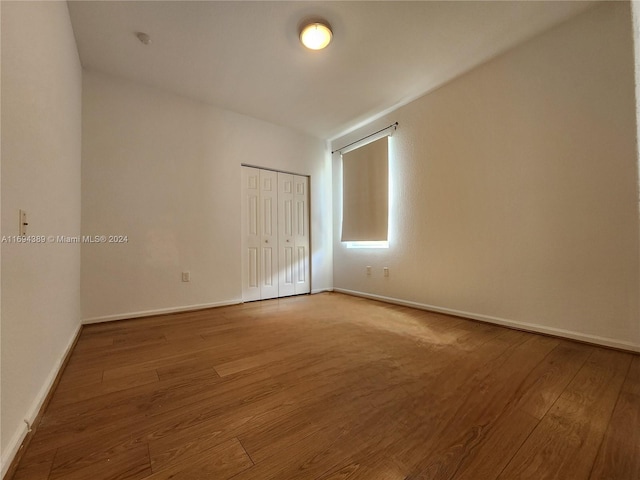 empty room with hardwood / wood-style floors