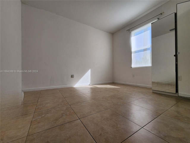 unfurnished room with light tile patterned floors