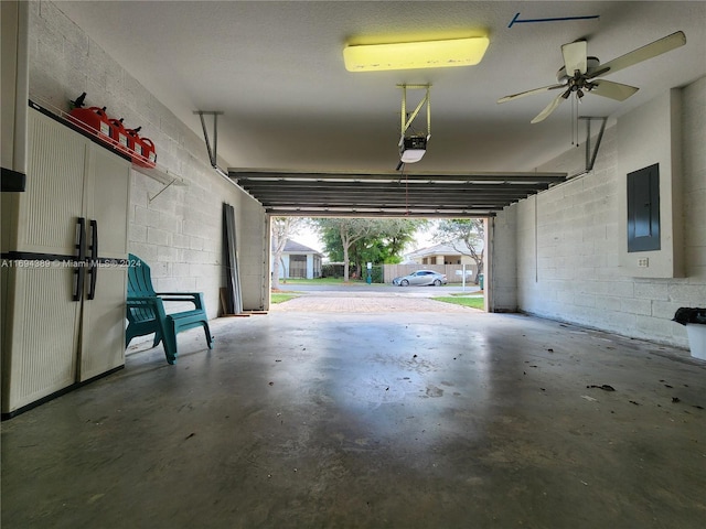 garage with electric panel, ceiling fan, and a garage door opener