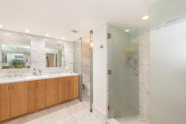 bathroom featuring tasteful backsplash, an enclosed shower, vanity, tile patterned flooring, and toilet