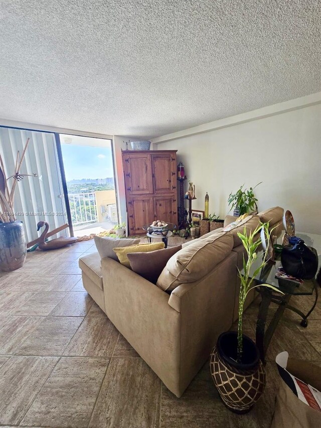 living room with floor to ceiling windows and a textured ceiling