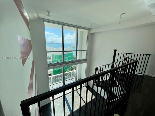 hallway with hardwood / wood-style flooring