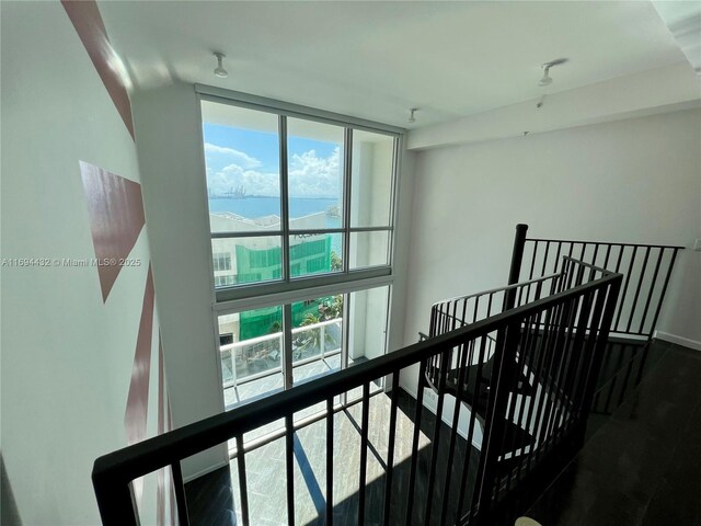 300 S Biscayne Blvd Unit 826, Miami, FL 33131 - hall with an upstairs landing, a water view, plenty of natural light, floor to ceiling windows, and wood finished floors