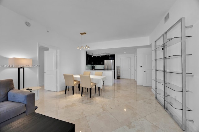 10 Aragon Ave Unit 810, Coral Gables, FL 33134 - dining area featuring light marble finish flooring and a chandelier
