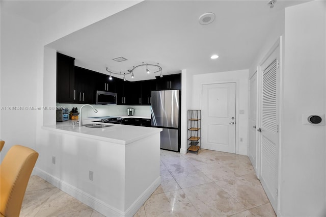 10 Aragon Ave Unit 810, Coral Gables, FL 33134 - kitchen featuring stainless steel appliances, dark cabinets, light countertops, and a peninsula
