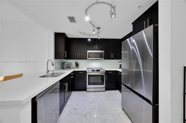 kitchen with sink, kitchen peninsula, and stainless steel appliances