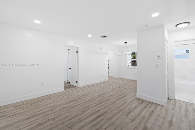 spare room with light hardwood / wood-style floors