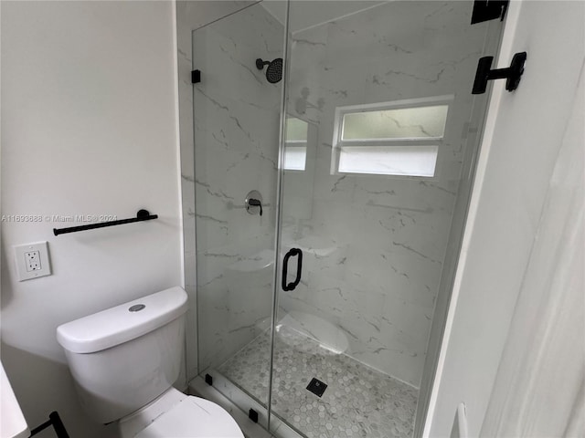 bathroom with an enclosed shower and toilet