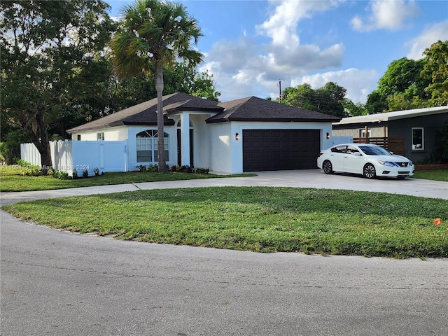 single story home with a front yard and a garage