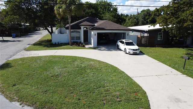 ranch-style home featuring a front yard and a garage