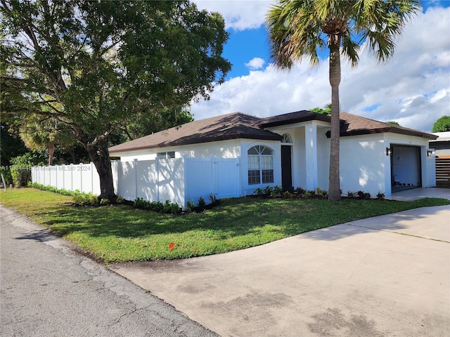 view of front of property featuring a front yard and a garage