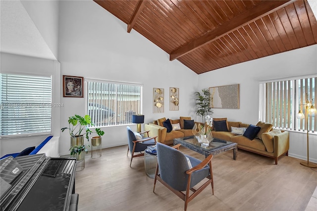 living room featuring a healthy amount of sunlight, light wood-type flooring, and high vaulted ceiling