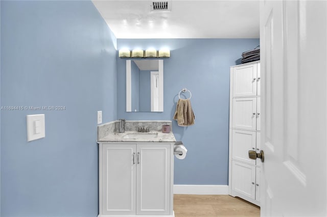 bathroom with hardwood / wood-style floors and vanity