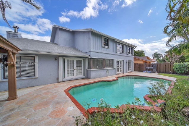 view of swimming pool featuring a patio and french doors