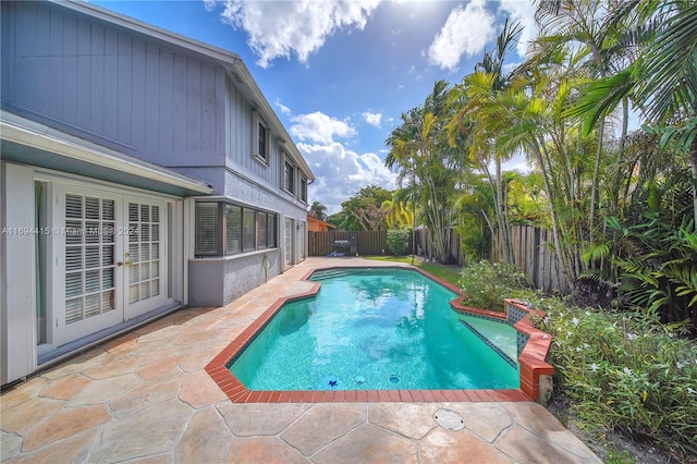 view of pool featuring a patio area and french doors