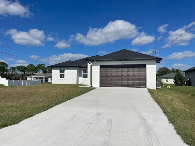 view of front of house featuring a front yard and a garage