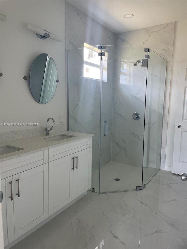 bathroom featuring vanity and an enclosed shower