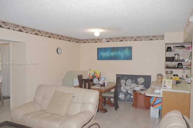 living room with light tile patterned floors and a textured ceiling