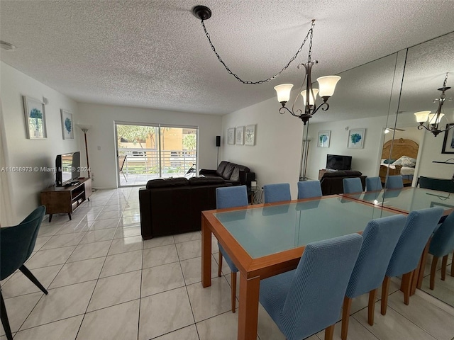 dining area with light tile patterned floors, a chandelier, and a textured ceiling