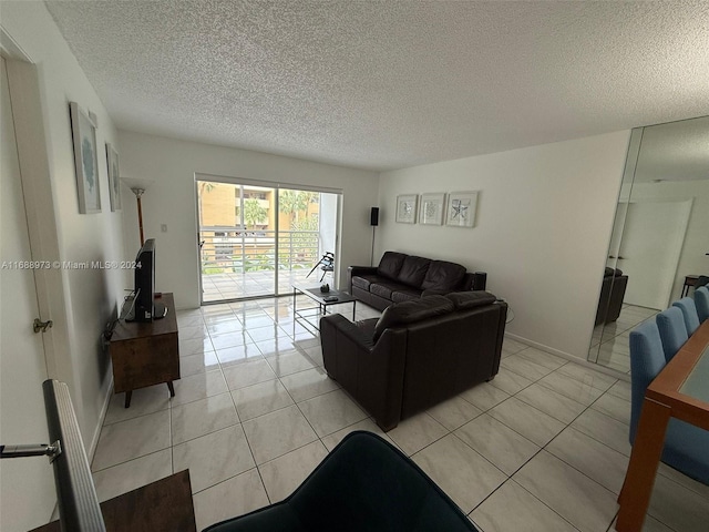 living room with light tile patterned flooring and a textured ceiling