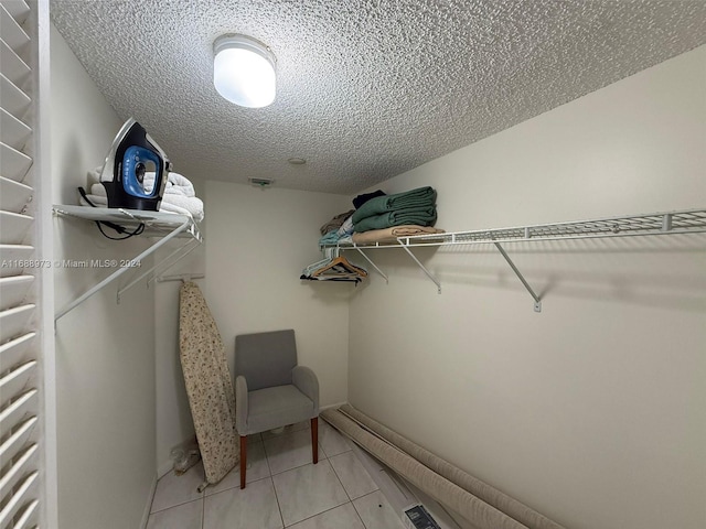 walk in closet featuring tile patterned flooring