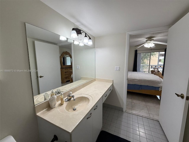 bathroom with tile patterned floors, vanity, and ceiling fan