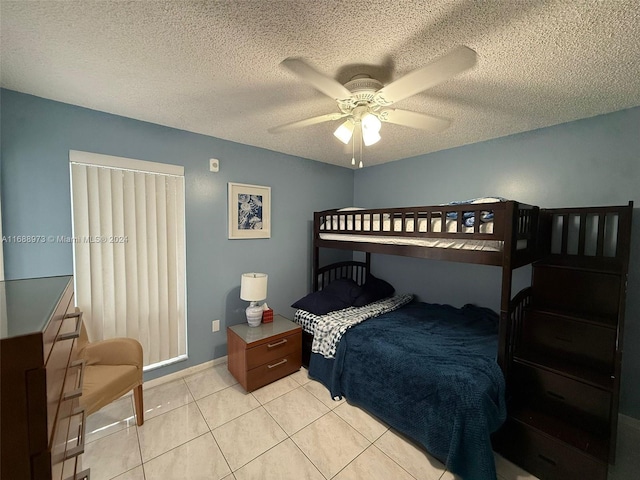 tiled bedroom featuring ceiling fan and a textured ceiling