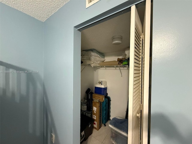 spacious closet with light tile patterned floors