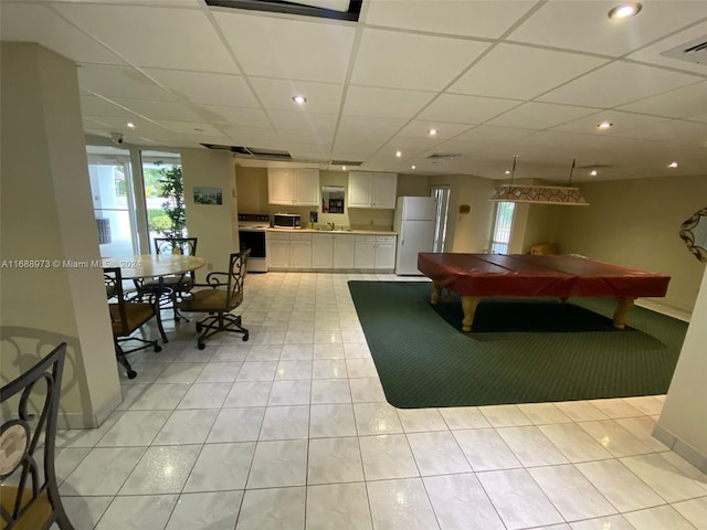 playroom with a paneled ceiling, light tile patterned floors, and billiards