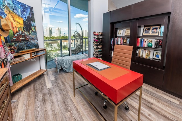 home office with light hardwood / wood-style floors