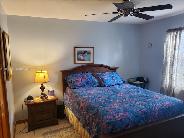 bedroom with ceiling fan and light tile patterned floors