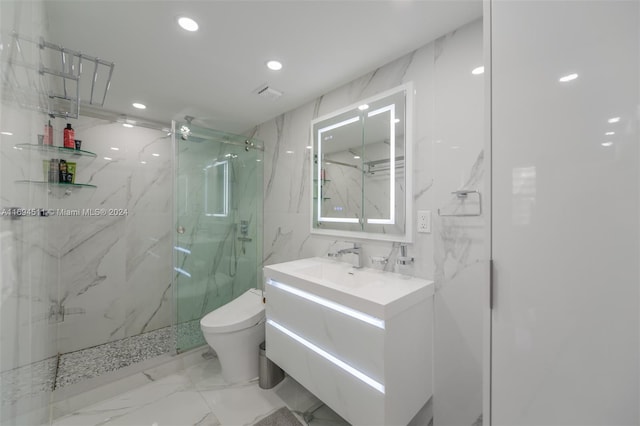 bathroom with vanity, a shower with shower door, and toilet