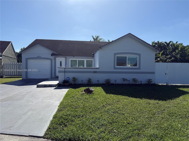 ranch-style house featuring a garage and a front lawn