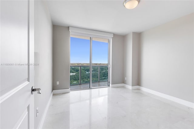 spare room featuring floor to ceiling windows