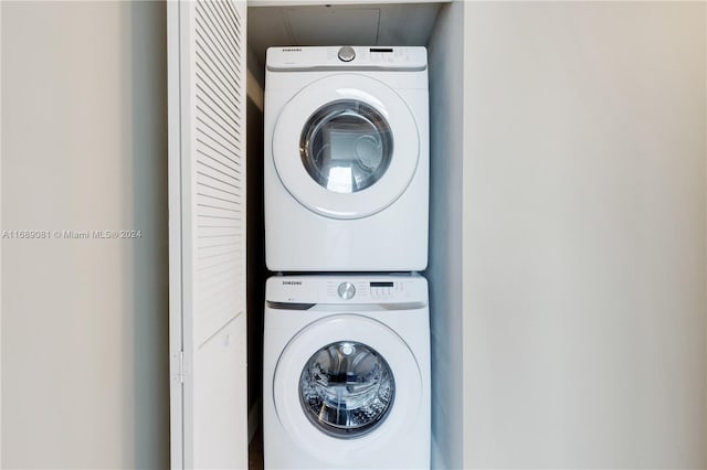 clothes washing area with stacked washer and dryer