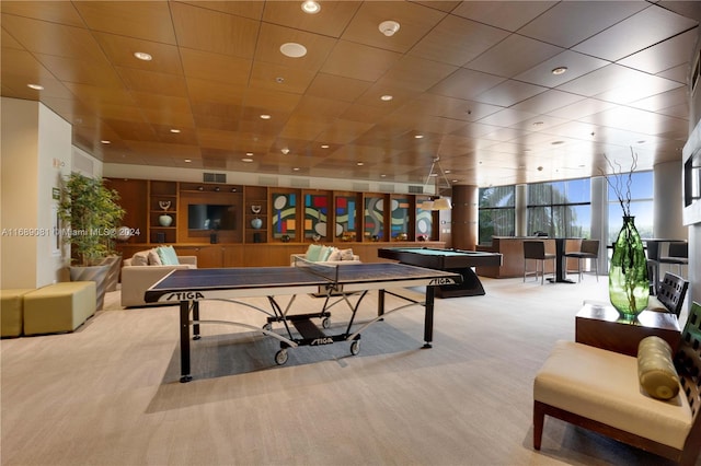 game room featuring expansive windows, light colored carpet, and pool table