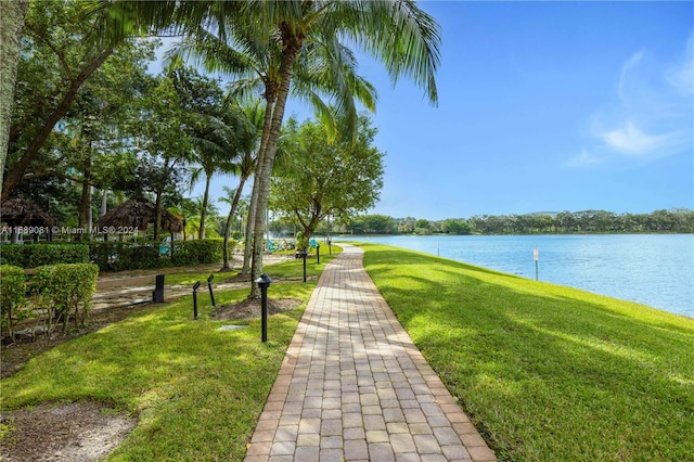 view of home's community featuring a lawn and a water view