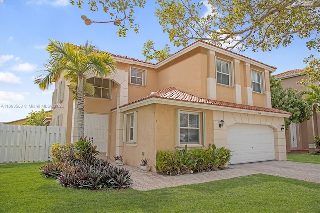 mediterranean / spanish-style home featuring a front lawn and a garage